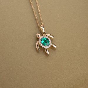 Gold 750 Sea turtle, oval shape emerald  and diamond pendant