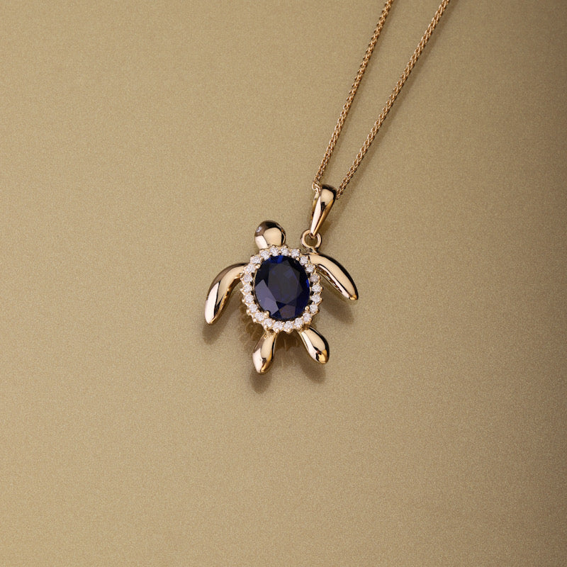 Gold 750 Sea turtle, oval shape blue sapphire  and diamond pendant